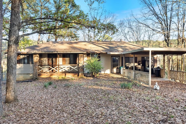 back of property with a carport