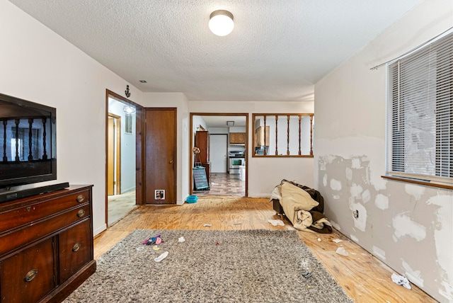 bedroom featuring a textured ceiling and light wood-type flooring