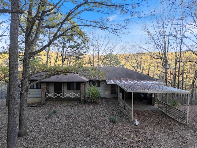 rear view of property with a carport