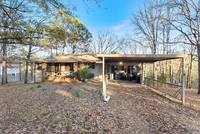 rear view of house with a carport and a porch