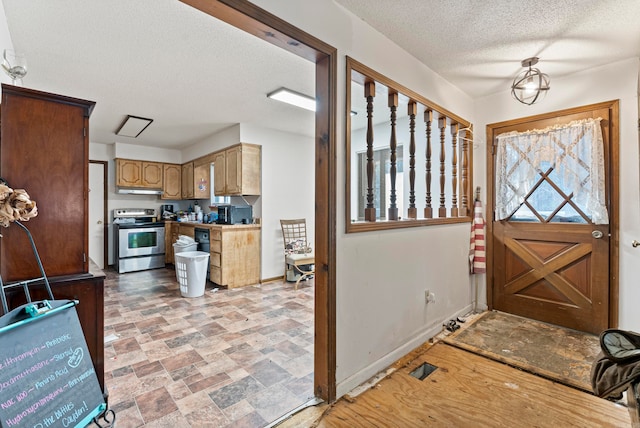 foyer entrance featuring a textured ceiling