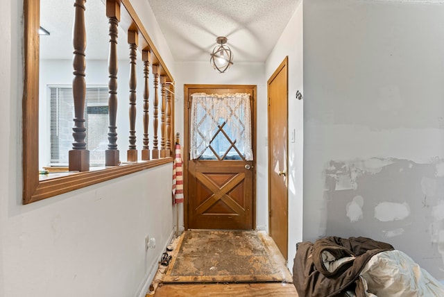 entryway with a textured ceiling