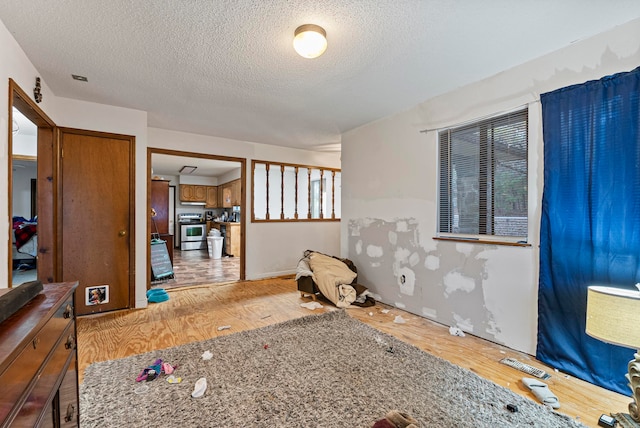 interior space with a textured ceiling and light hardwood / wood-style floors