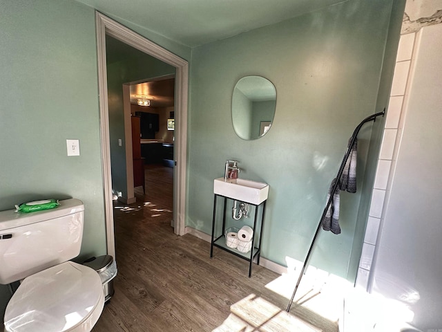 bathroom featuring sink, wood-type flooring, and toilet