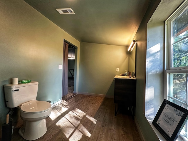 bathroom with hardwood / wood-style flooring, vanity, and toilet