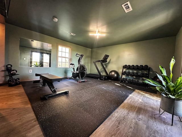 exercise room with wood-type flooring