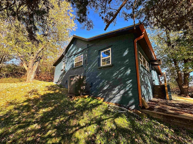 view of side of home with a lawn