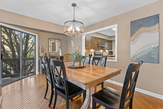 dining space with a chandelier and light wood-type flooring