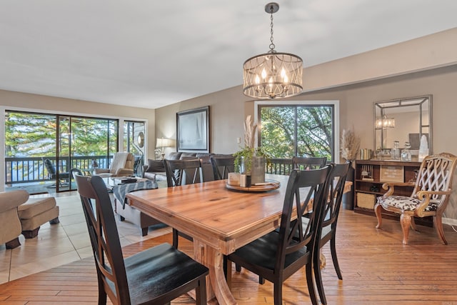 dining area with a chandelier, light hardwood / wood-style floors, and plenty of natural light