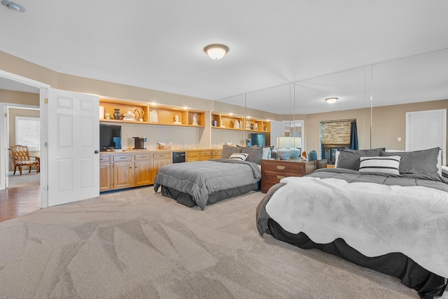 bedroom featuring indoor bar and light colored carpet