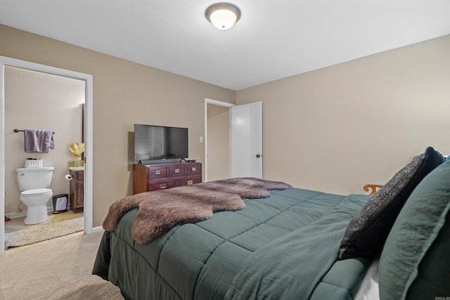 carpeted bedroom with connected bathroom