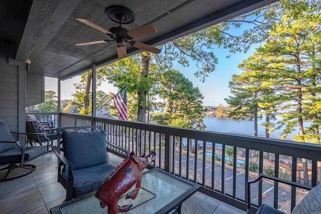 wooden terrace featuring a water view and ceiling fan