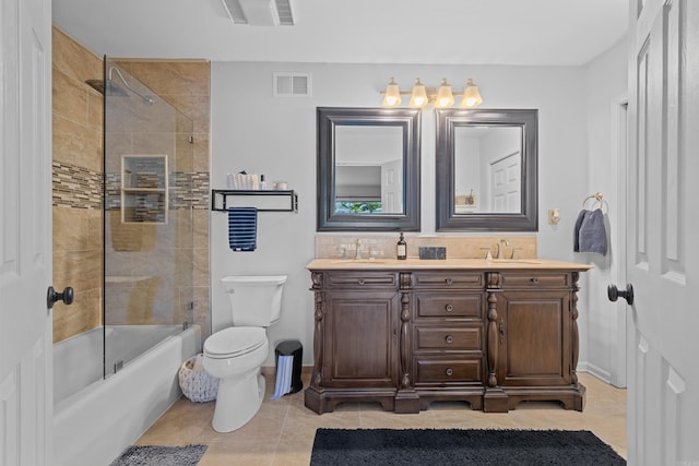 full bathroom featuring tile patterned floors, toilet, vanity, and tiled shower / bath