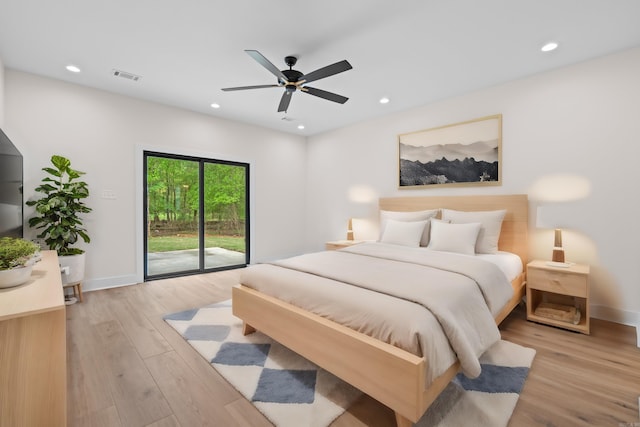 bedroom featuring access to outside, light hardwood / wood-style flooring, and ceiling fan