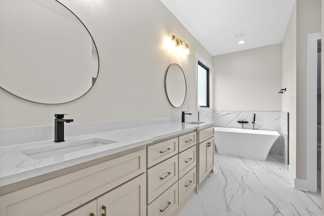 bathroom featuring vanity and a tub