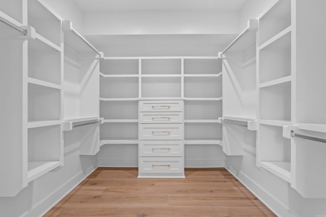 spacious closet with light hardwood / wood-style flooring