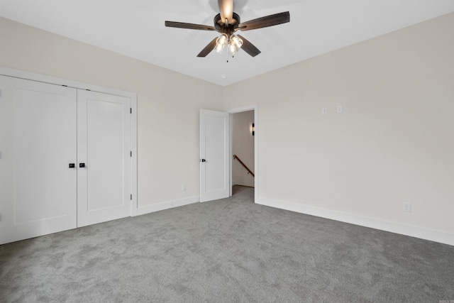 unfurnished bedroom with carpet flooring, a closet, and ceiling fan