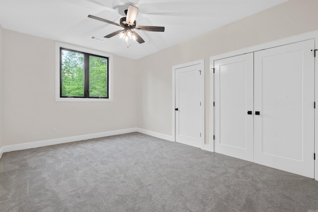 unfurnished bedroom featuring ceiling fan and carpet floors