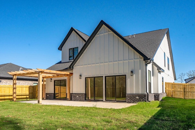 rear view of house featuring a lawn, a patio area, and a pergola