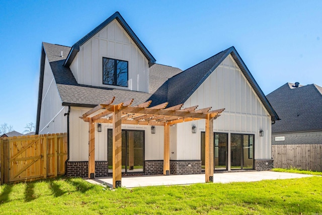 back of house with a pergola, a patio area, and a yard