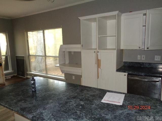 kitchen with crown molding, dishwasher, white cabinets, and hardwood / wood-style floors