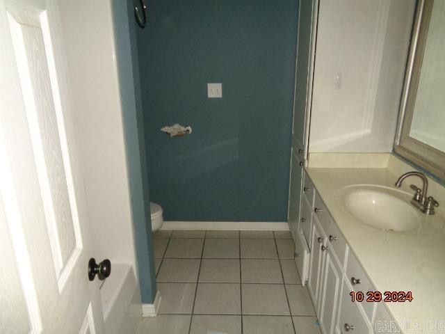 bathroom featuring tile patterned floors, vanity, and toilet