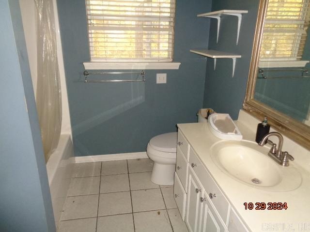 full bathroom featuring tile patterned floors, plenty of natural light, vanity, and toilet