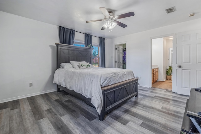 bedroom with ensuite bathroom, a walk in closet, hardwood / wood-style flooring, ceiling fan, and a closet