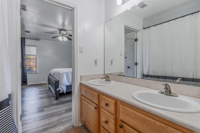 bathroom featuring hardwood / wood-style flooring, ceiling fan, and vanity