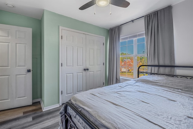 bedroom featuring wood-type flooring, a closet, and ceiling fan