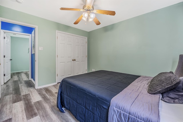 bedroom featuring wood-type flooring, a closet, and ceiling fan