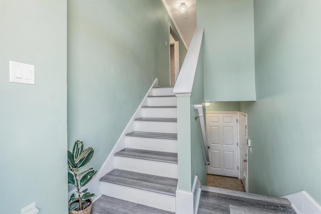 staircase with wood-type flooring