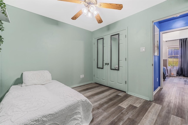 bedroom featuring a closet, ceiling fan, and dark hardwood / wood-style flooring