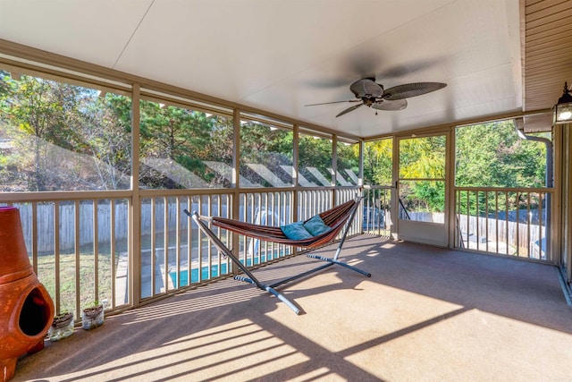 unfurnished sunroom featuring ceiling fan