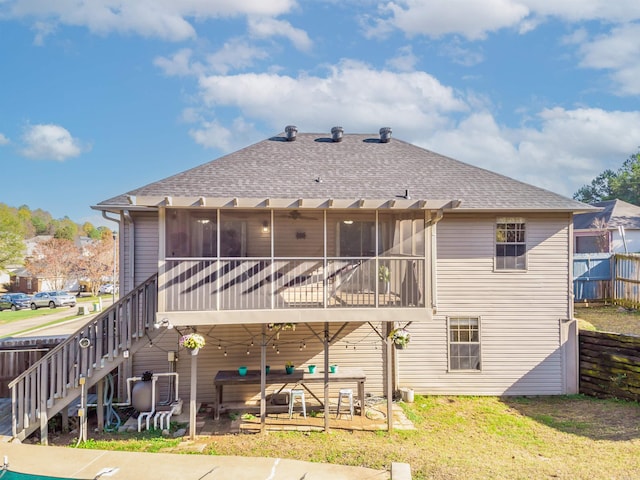 rear view of house featuring a patio and a sunroom