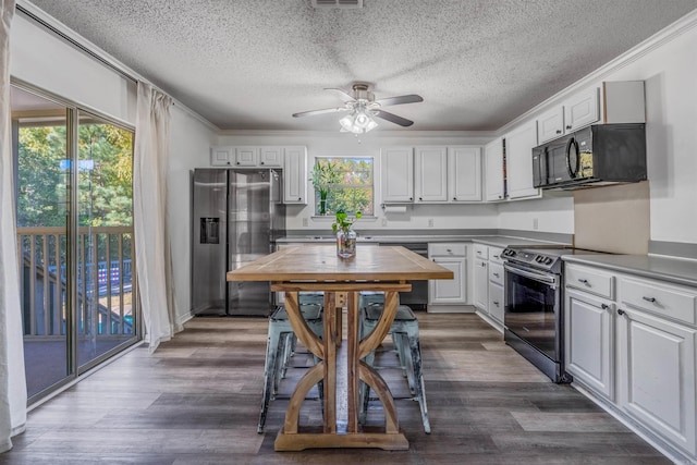 kitchen featuring dark hardwood / wood-style flooring, white cabinetry, ceiling fan, and black appliances