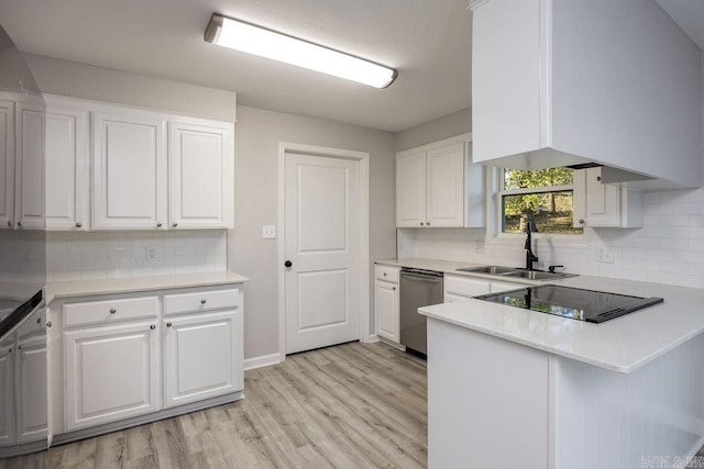 kitchen with light wood-type flooring, white cabinetry, and backsplash