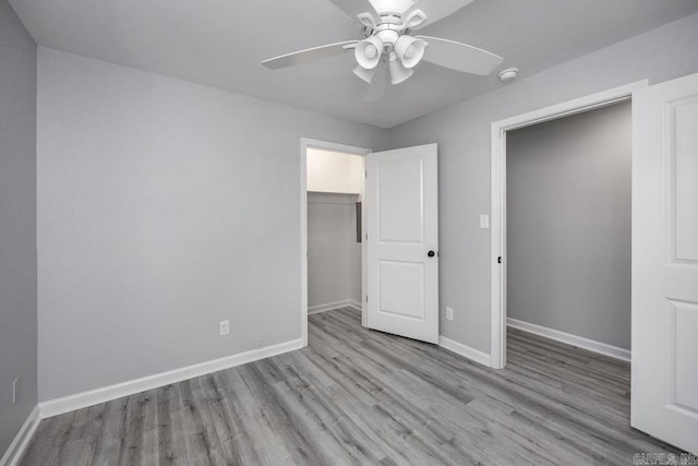 unfurnished bedroom with a closet, light hardwood / wood-style flooring, and ceiling fan