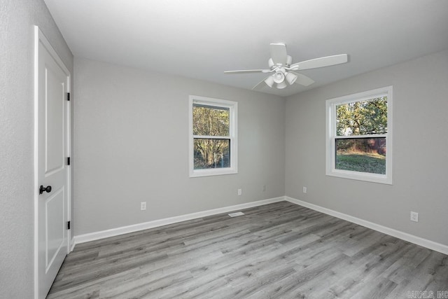 unfurnished room with ceiling fan, plenty of natural light, and light hardwood / wood-style floors