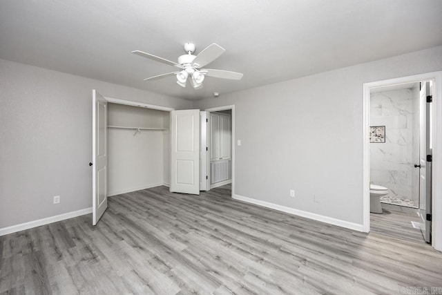 unfurnished bedroom with a closet, light hardwood / wood-style floors, ensuite bath, and ceiling fan