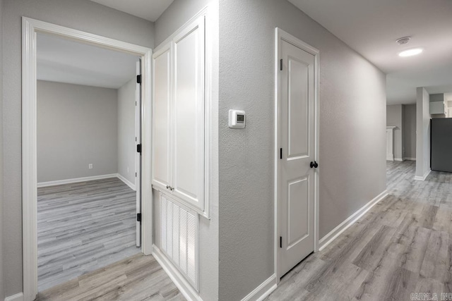 corridor with light wood-type flooring