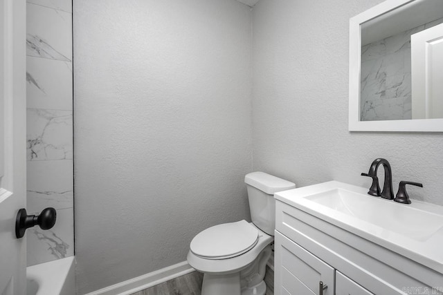 bathroom with wood-type flooring, vanity, and toilet