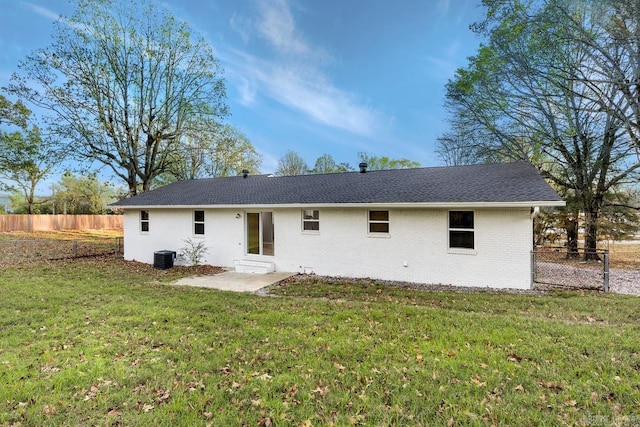 back of house with a lawn