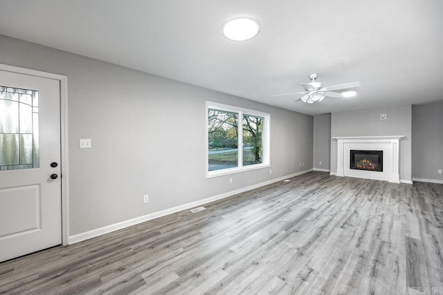 unfurnished living room featuring light hardwood / wood-style floors and ceiling fan