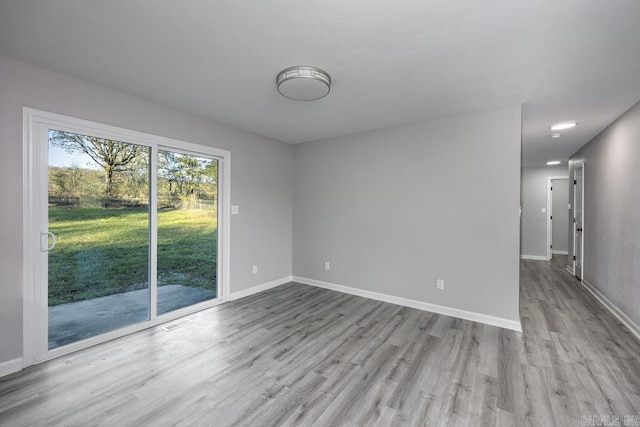 spare room featuring light wood-type flooring