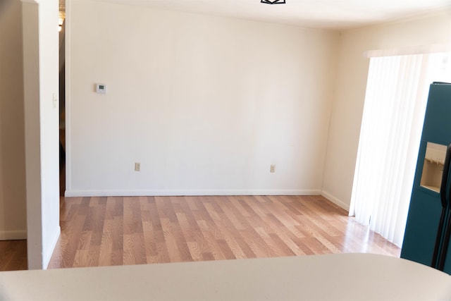 empty room with light hardwood / wood-style floors