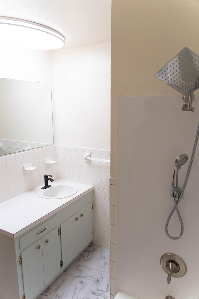 bathroom featuring vanity and tile walls