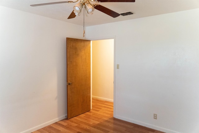 empty room with ceiling fan and light wood-type flooring