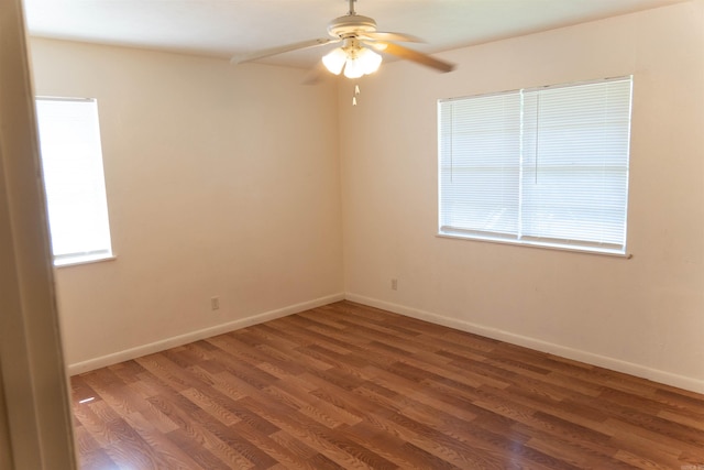 unfurnished room with ceiling fan, dark hardwood / wood-style flooring, and a wealth of natural light