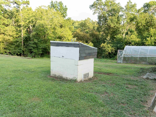 view of outdoor structure with a lawn